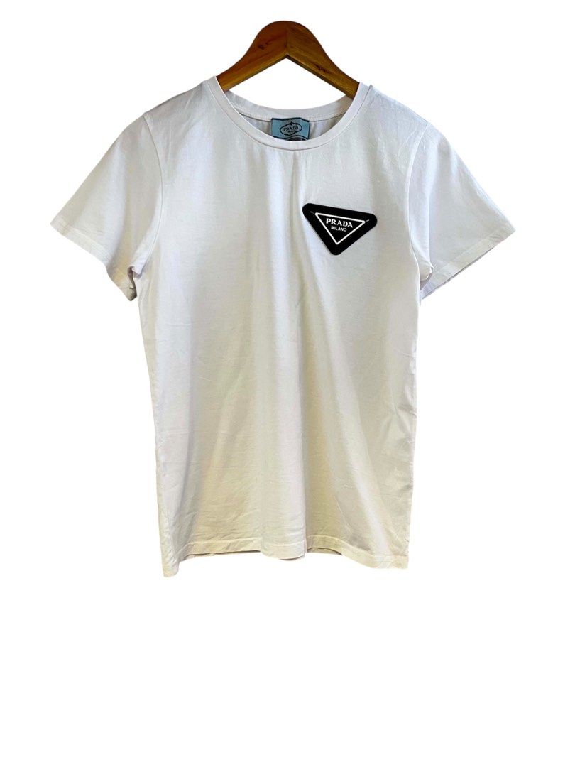 Prada Milano White T-Shirt (Category: Tshirts & Polo Shirts ) located in Bacolod City. Submitted by unkemptrags (Listing ID 1436956831, Image 1). Description: - Prada white t-shirt - Black triangle logo patch on chest - 17.5by26 -excellent condition -849 freeship.