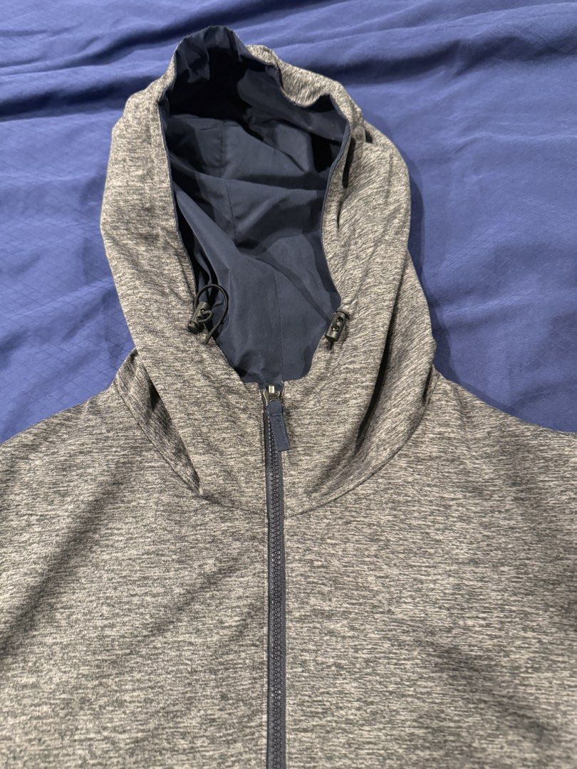 Reversible Hooded Jacket (Category: Coats, Jackets and Outerwear) located in Subang Jaya. Submitted by jacob25819 (Listing ID 1436996708, Image 2). Description: - Reversible design: Grey exterior, navy blue interior - Full-length zipper - Hood with adjustable drawstrings - Two front pockets - Cuffed sleeves - Lightweight material.