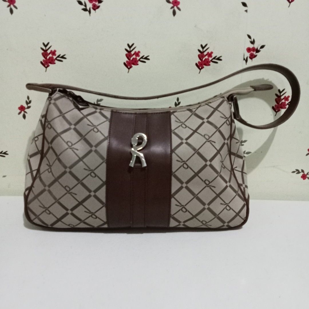 Roberta di Camerino Handbag (Category: Luxury Bags & Wallets) located in Hinigaran. Submitted by faye_fab02 (Listing ID 1436854613, Image 1). Description: - Brown and beige patterned handbag - Brown leather accent - Silver logo detail - Single handle - Zipper closure.