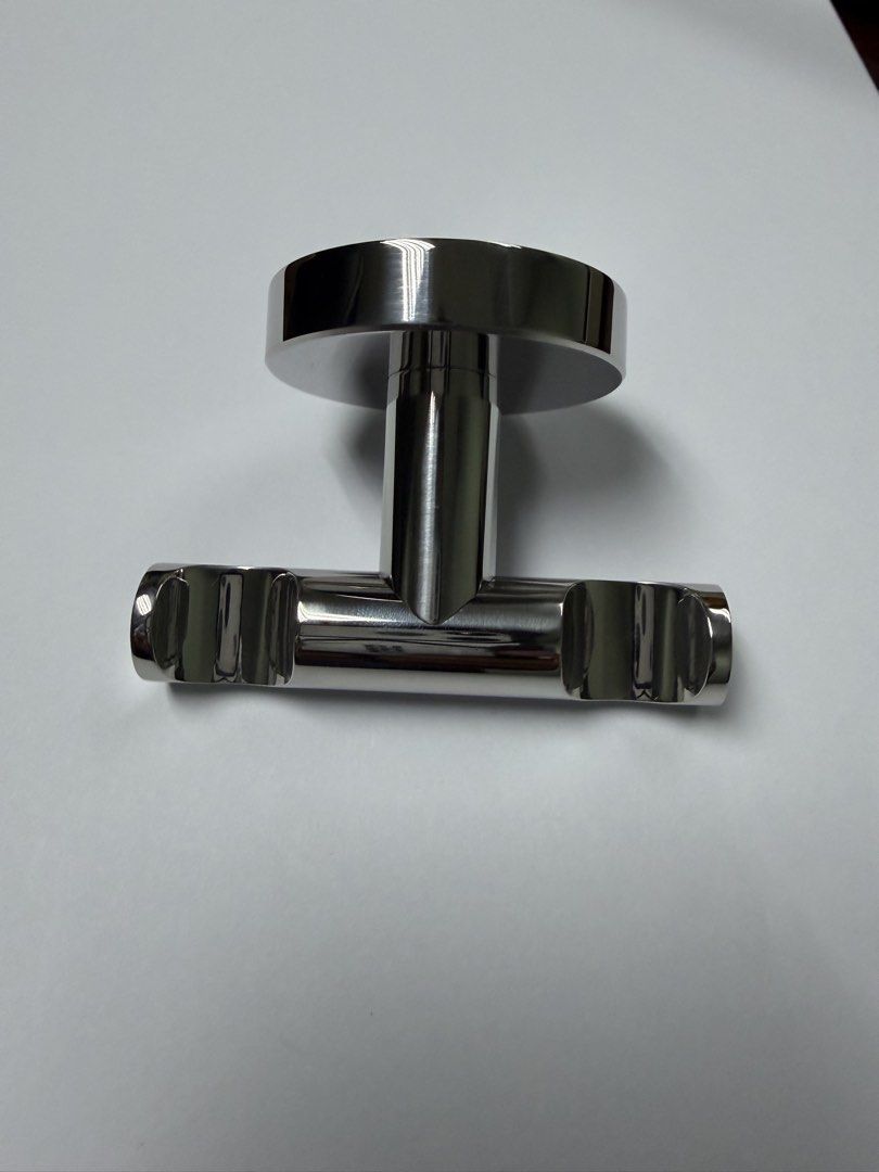 Stainless Steel Towel and Robe Hook (Category: Bedding & Towels) located in Makati City. Submitted by monkeykingo (Listing ID 1436947041, Image 1). Description: - Stainless steel towel hooks - Circular base - T-shaped design - Two horizontal bars for towels - Polished, reflective surface - Durable metal construction.