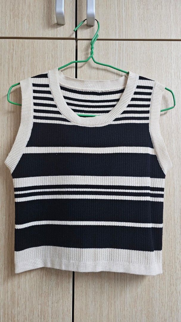 Striped Knit Top (Category: Sleeveless) located in Singapore. Submitted by baengg (Listing ID 1436967880, Image 1). Description: - Navy and white striped knit top - Sleeveless design - Round neckline - Suitable for layering or wearing alone - Ideal for casual and semi-formal events.
