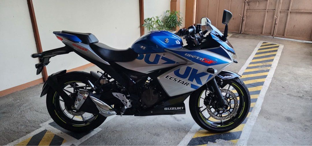 Suzuki Gixxer SF 250 (Category: Motorbikes for Sale) located in Manila. Submitted by riadananapalcruz79 (Listing ID 1436979388, Image 2). Description: Suzuki Gixxer SF 250 motorcycle with blue and silver color scheme. Features include a sporty design, black wheels with yellow accents, and a visible exhaust. The bike has the Suzuki and Ecstar branding. Original paper brand new last year lng binili 1k odo lng po owner nsa ibang bansa pero ready n u