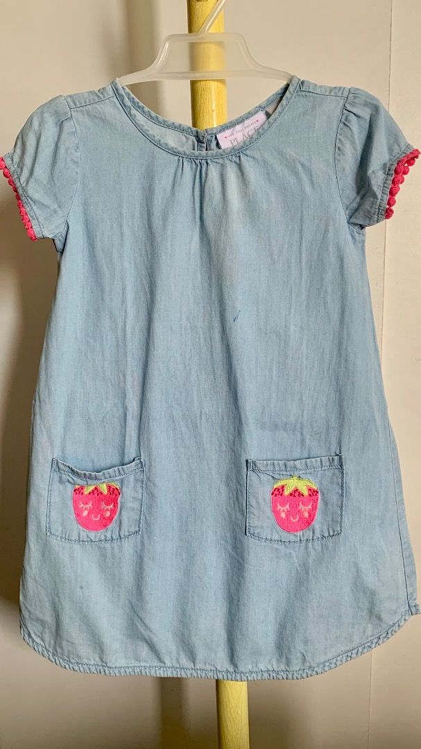 The Children's Place Denim Dress with Strawberry Pockets (Category: Babies & Kids Fashion) located in Quezon City. Submitted by warmrabbit_414908 (Listing ID 1436877878, Image 1). Description: - The Children's Place denim dress - Size: 4T - Features: Strawberry embroidery on front pockets, pink trim, keyhole back - Color: Light blue - Style: Short sleeves.
