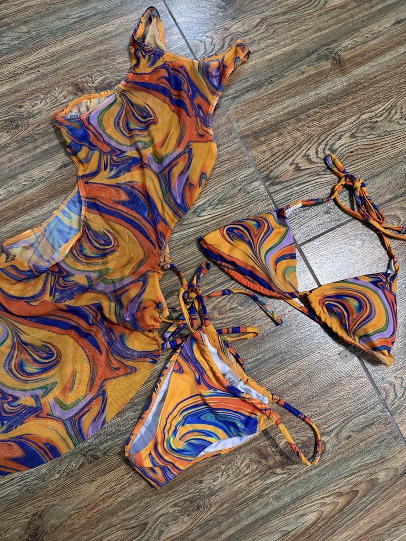 Three Piece Swirl Print Bikini Set with Cover Up (Category: Bikinis & Swimsuits) located in Angeles City. Submitted by diana.18 (Listing ID 1436913549, Image 3). Description: - Swirl print bikini set (orange, blue, purple) - Includes: Halter-neck bikini top, matching bottom, and cover-up dress - Cover-up features side cutouts and tie details - Size: S Used once. Rfs decluttering.