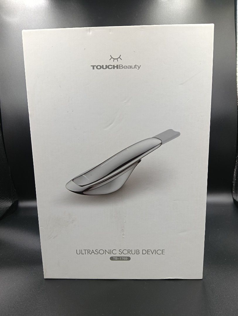 TOUCHBeauty Ultrasonic Scrub Device TB-1769 (Category: Face Care) located in La Trinidad. Submitted by cherishedtreasures (Listing ID 1436932828, Image 3). Description: - TOUCHBeauty Ultrasonic Scrub Device TB-1769 - Silver design - Rechargeable and water-resistant - Includes charging cable and accessories - Designed for facial exfoliation and cleansing - Box includes diagrams for easy use.