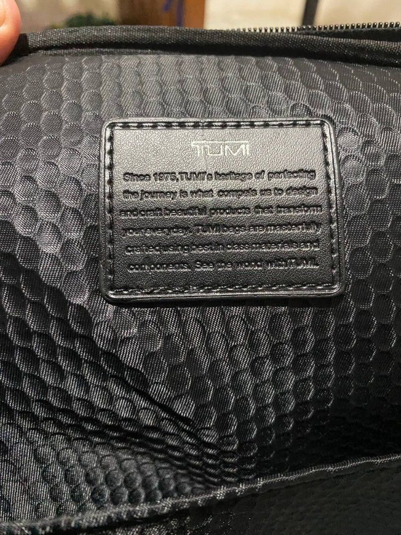 Tumi Backpack (Category: Luxury Bags & Wallets) located in Talacogon. Submitted by mr1070 (Listing ID 1436834698, Image 3). Description: - Tumi backpack - Color: Black - Multiple compartments for organization - Top handle for easy carrying - Includes a Tumi luggage tag - Textured design - Metal logo plate - Lined interior - Zipper closure - Adjustable straps.