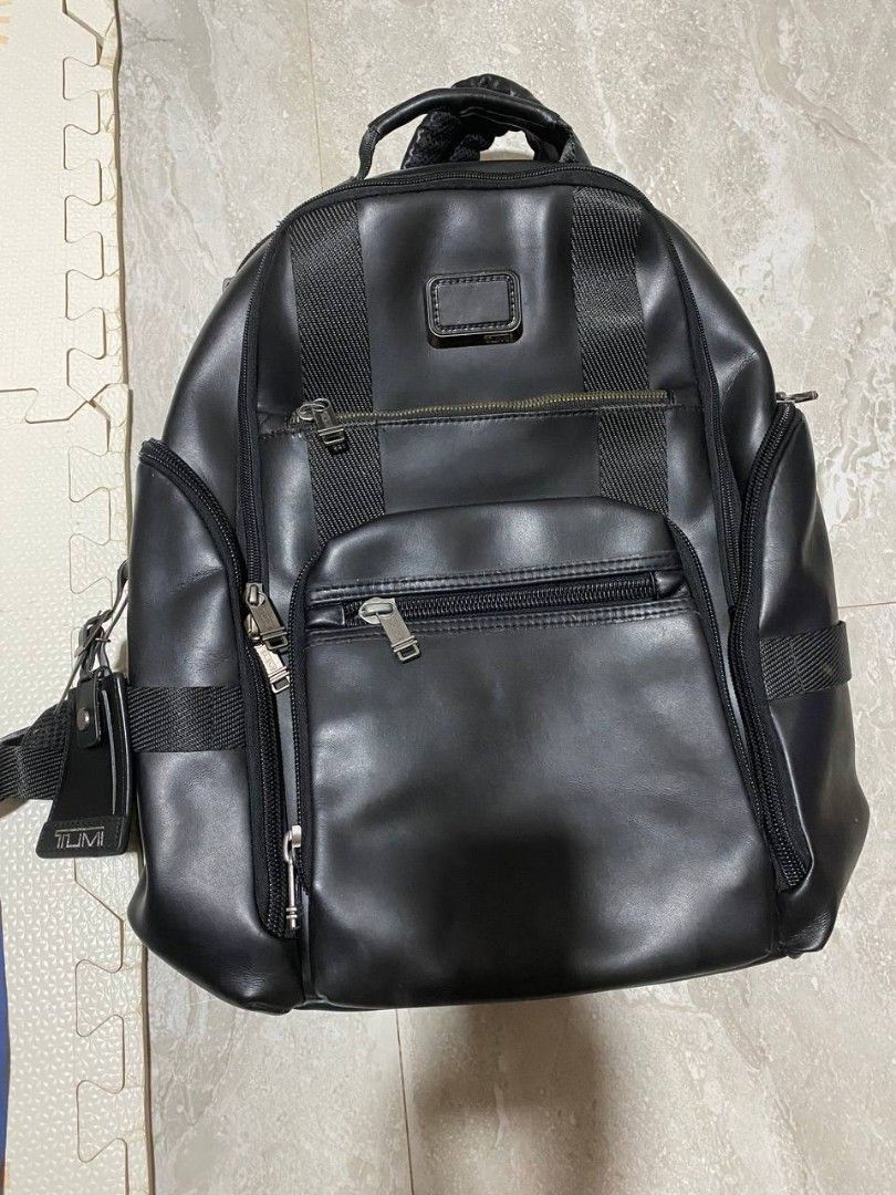 Tumi Backpack (Category: Luxury Bags & Wallets) located in Talacogon. Submitted by mr1070 (Listing ID 1436834698, Image 2). Description: - Tumi backpack - Color: Black - Multiple compartments for organization - Top handle for easy carrying - Includes a Tumi luggage tag - Textured design - Metal logo plate - Lined interior - Zipper closure - Adjustable straps.