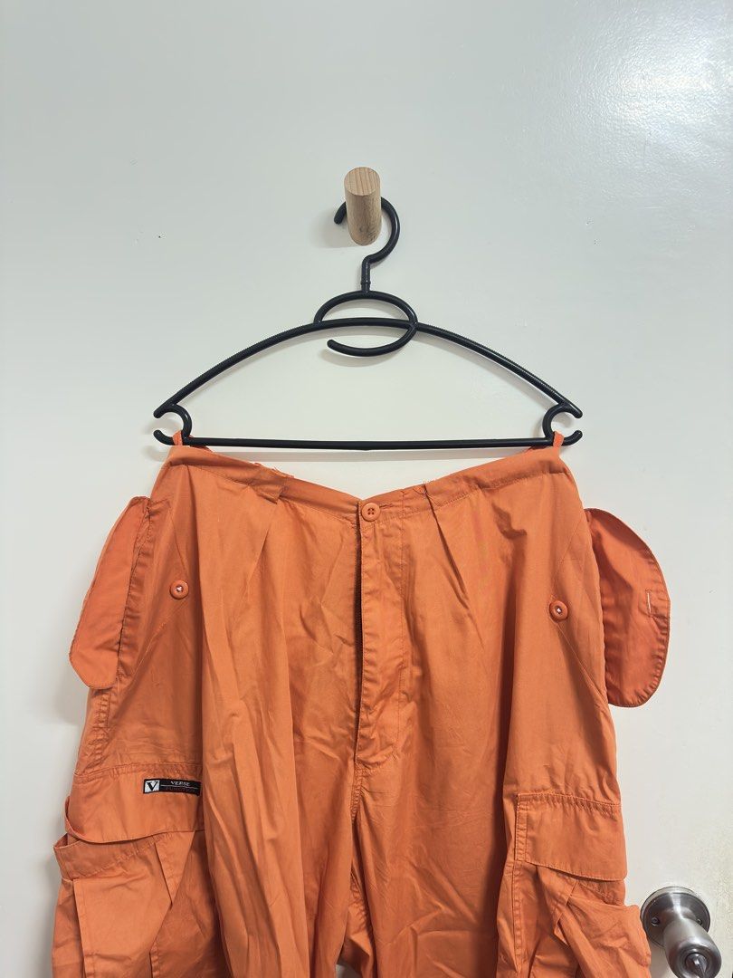 Verge Orange Cargo Pants (Category: Other Bottoms) located in Manila. Submitted by hutfris (Listing ID 1436888855, Image 2). Description: - Verge orange cargo pants - Multiple pockets (front and sides) - Button closure at waist - Button detail on side pockets - Verge logo detail - Solid orange color.