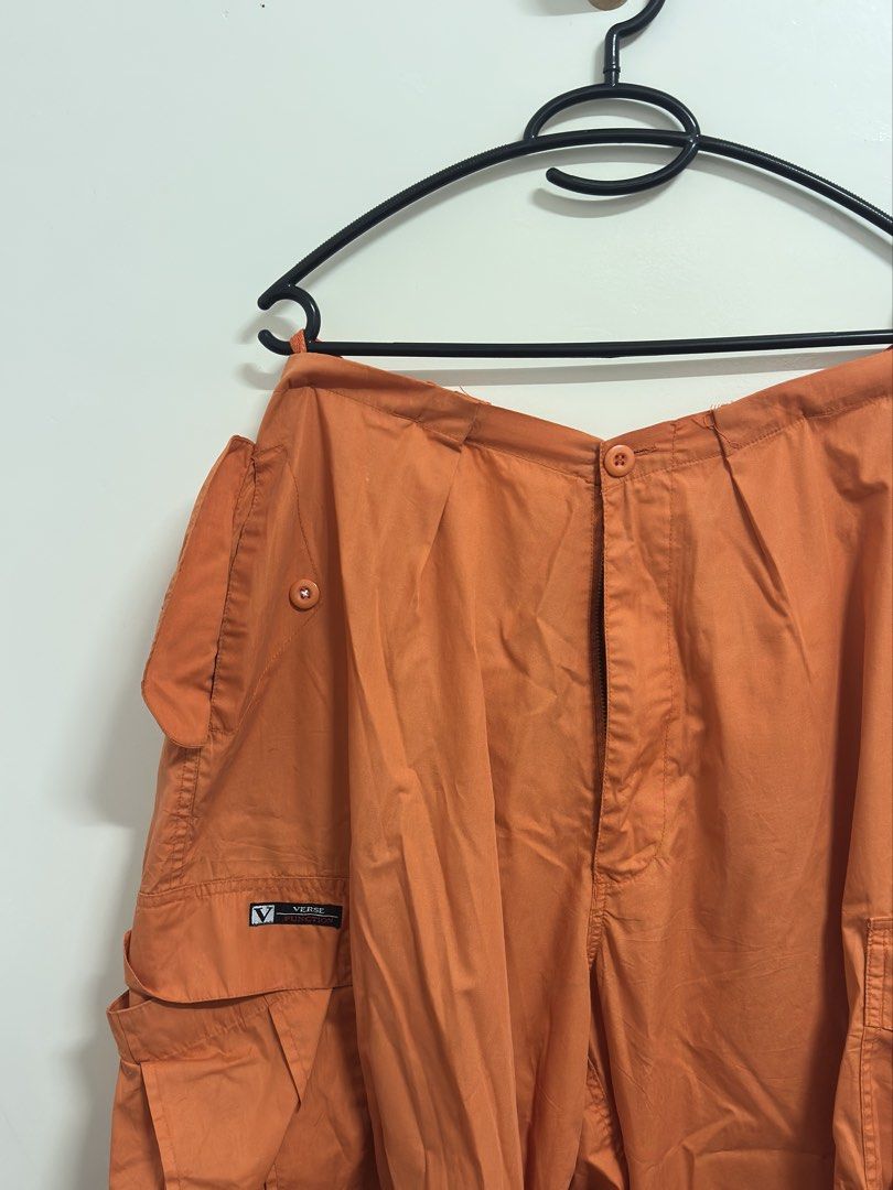 Verge Orange Cargo Pants (Category: Other Bottoms) located in Manila. Submitted by hutfris (Listing ID 1436888855, Image 1). Description: - Verge orange cargo pants - Multiple pockets (front and sides) - Button closure at waist - Button detail on side pockets - Verge logo detail - Solid orange color.