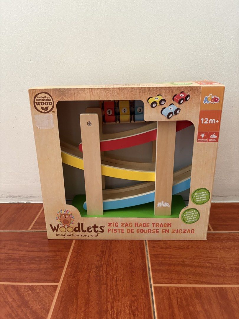 Woodlets Zig Zag Race Track (Category: Educational & Learning Toys) located in Quezon City. Submitted by mmaryf (Listing ID 1436846212, Image 1). Description: - Woodlets Zig Zag Race Track - Includes 3 colorful wooden race cars - Suitable for ages 12 months+ - Features a zig-zag design - Made of wood - Promotes imagination and fine motor skills - Fun and engaging toy.