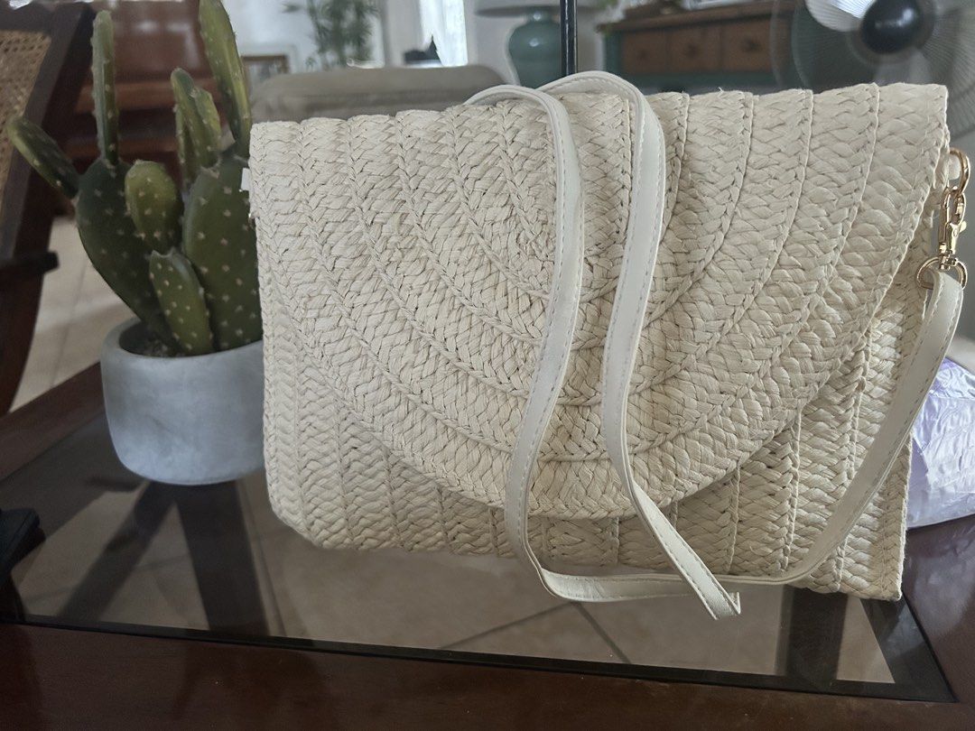 Woven Clutch Bag with Shoulder Strap (Category: Shoulder Bags) located in Quezon City. Submitted by asiaco (Listing ID 1436851302, Image 1). Description: Woven clutch bag with flap closure and detachable strap. Features one interior pocket. Versatile for any occasion, especially during summer. .
