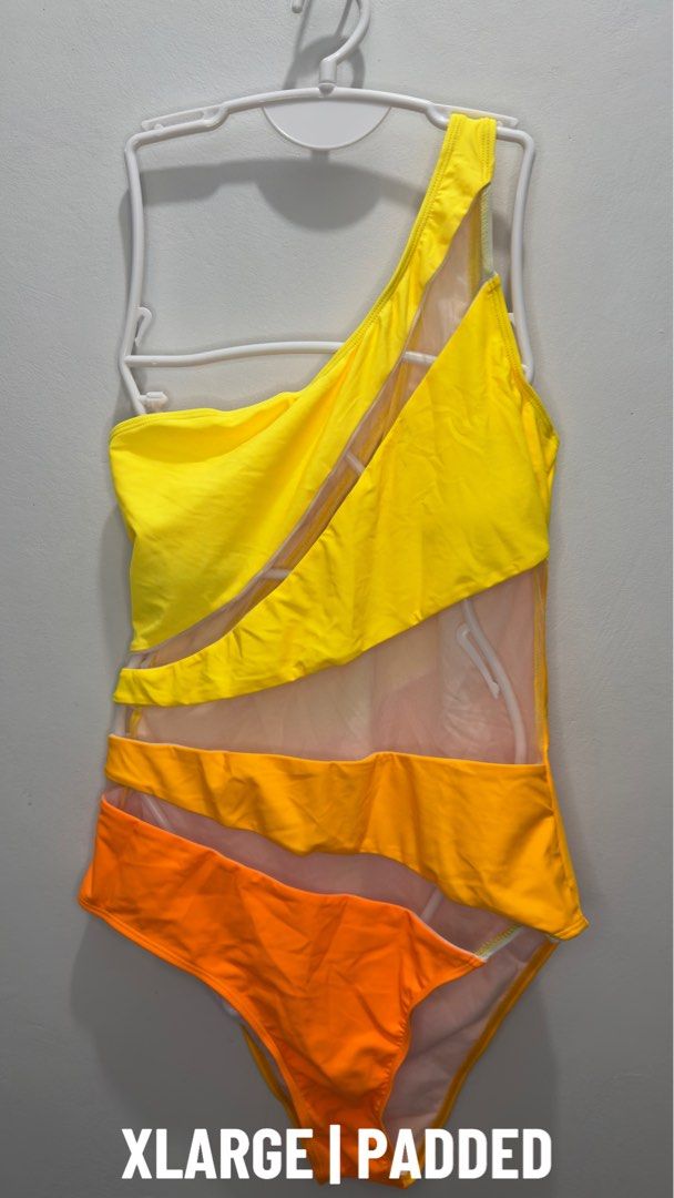 XL Padded One-Shoulder Swimsuit (Category: Bikinis & Swimsuits) located in Manila. Submitted by casasantina.ph (Listing ID 1436935200, Image 1). Description: - Stylish one-shoulder swimsuit - Vibrant yellow, orange, and white colors - Unique mesh detailing - Padded for comfort and support - XL size - Ideal for beach or pool.