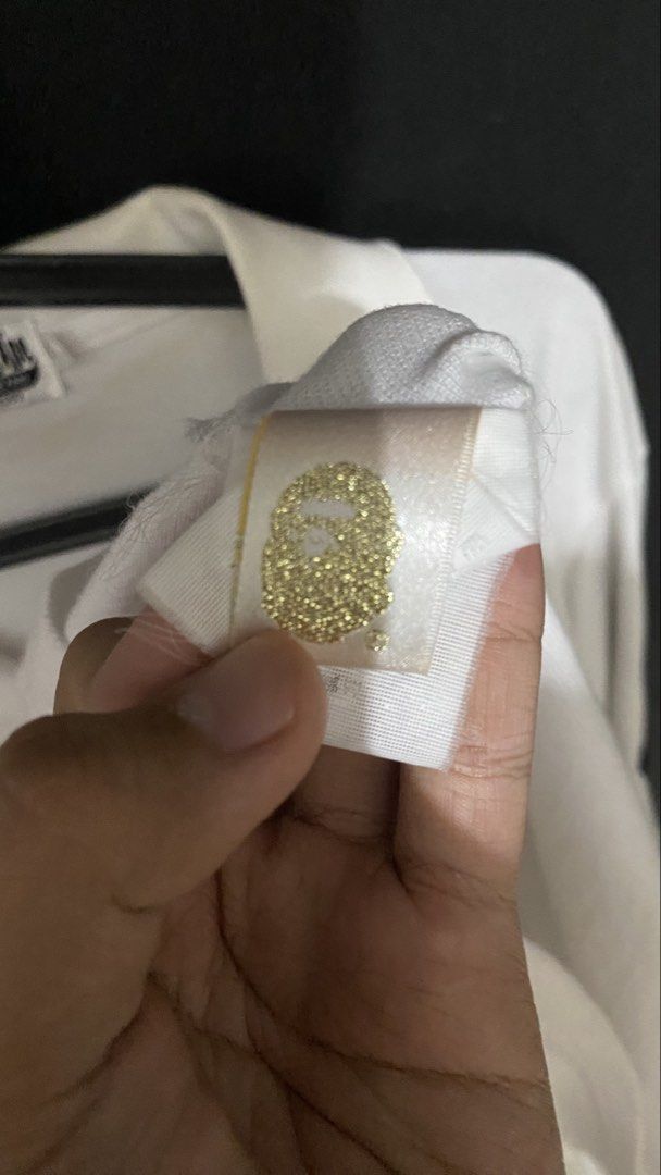 A Bathing Ape BAPE Polo Shirt White Size M (Category: Tshirts & Polo Shirts ) located in Manila. Submitted by hustlehardpalagi (Listing ID 1441307763, Image 3). Description: - White A Bathing Ape (BAPE) polo shirt - Iconic ape head logo embroidered on the chest - '3' graphic detail on both sleeves - Tagged size Medium (M) - Ideal for everyday casual wear.