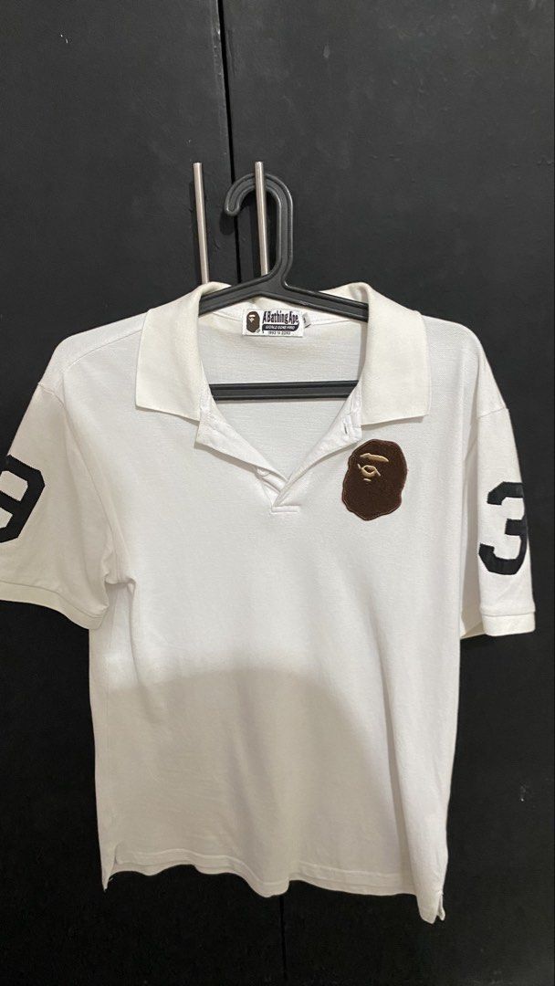 A Bathing Ape BAPE Polo Shirt White Size M (Category: Tshirts & Polo Shirts ) located in Manila. Submitted by hustlehardpalagi (Listing ID 1441307763, Image 1). Description: - White A Bathing Ape (BAPE) polo shirt - Iconic ape head logo embroidered on the chest - '3' graphic detail on both sleeves - Tagged size Medium (M) - Ideal for everyday casual wear.