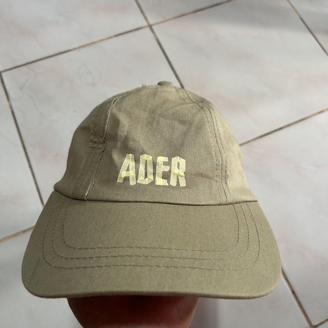 Ader Error Beige Cap 🔥 (Category: Caps & Hats) located in Jinoba-an. Submitted by eegiboy (Listing ID 1441207592, Image 2). Description: - Beige Ader Error cap - Adjustable strap with black buckle at the back - Signs of wear on stitching and fabric, particularly around the edges issue: stain ( see last pic) 600plussf Dm me if interested thankyou.
