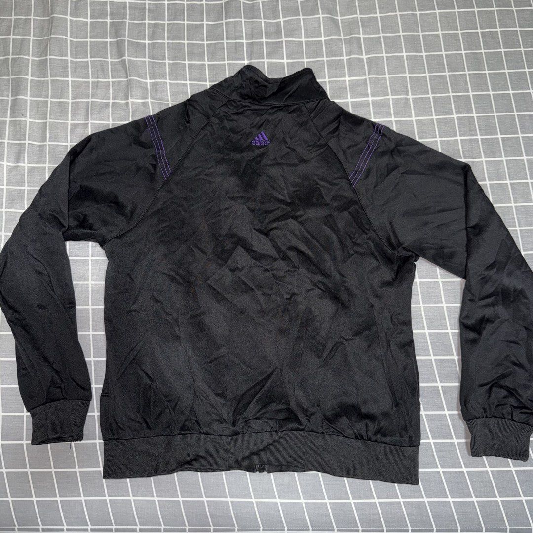 Adidas Black & Purple Track Jacket Size L (Category: Coats, Jackets and Outerwear) located in Singapore. Submitted by dowoonius (Listing ID 1441359356, Image 2). Description: - Adidas track jacket - Colour: Black with purple accents - Size: L - Features: Full zip closure, ribbed cuffs and hem - Perfect for workouts or casual wear Delivery (+$3.5).