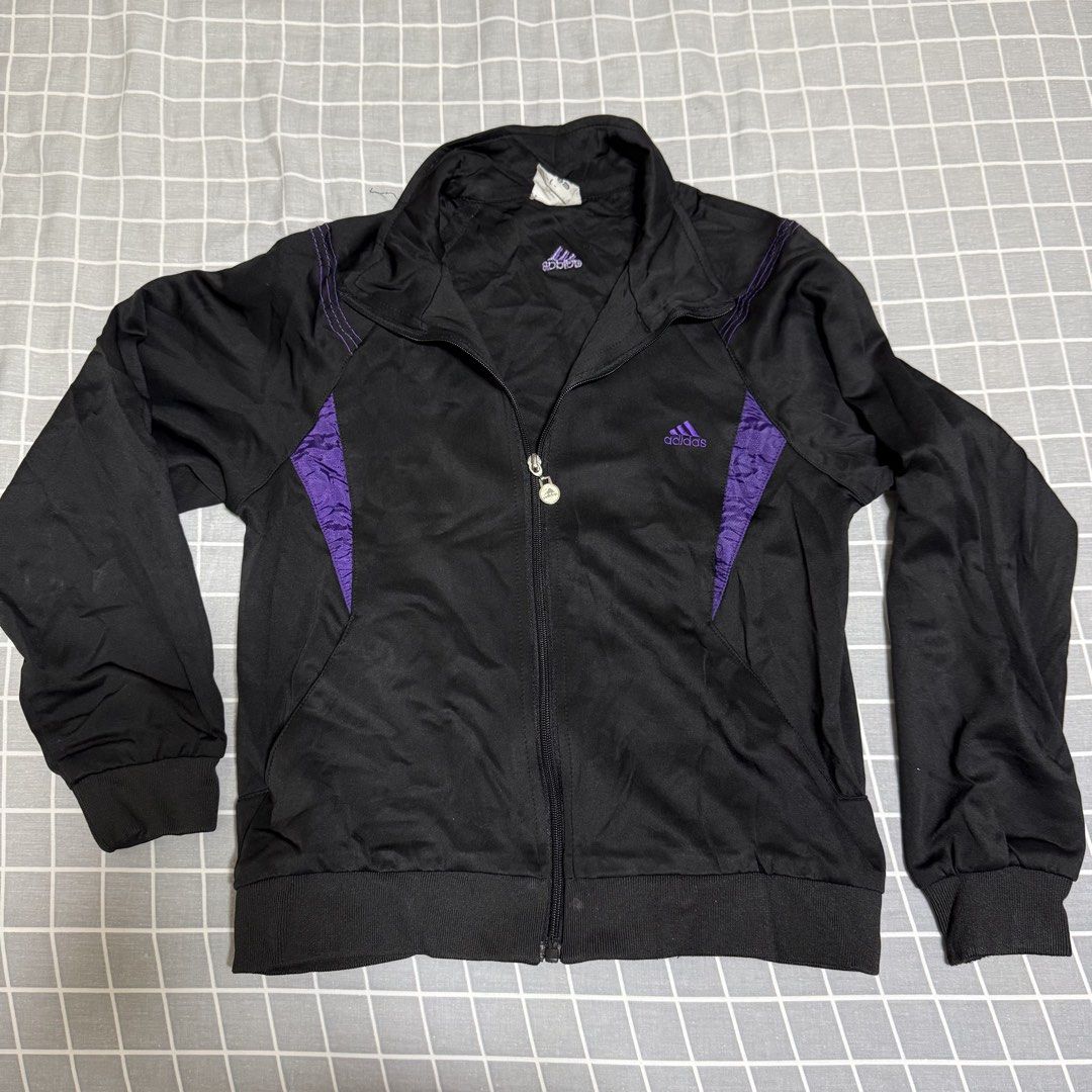 Adidas Black & Purple Track Jacket Size L (Category: Coats, Jackets and Outerwear) located in Singapore. Submitted by dowoonius (Listing ID 1441359356, Image 1). Description: - Adidas track jacket - Colour: Black with purple accents - Size: L - Features: Full zip closure, ribbed cuffs and hem - Perfect for workouts or casual wear Delivery (+$3.5).