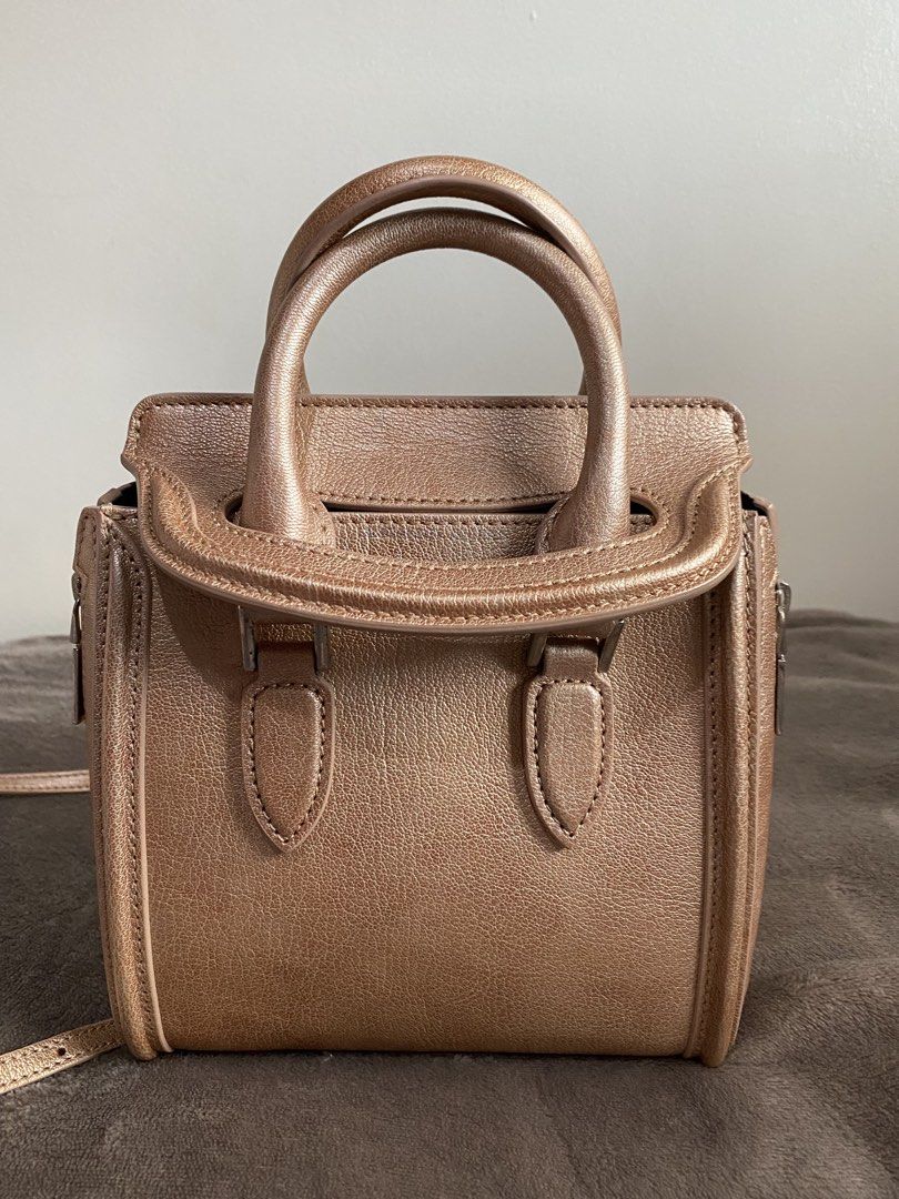 Alexander McQueen Metallic Rose Gold Mini Bag (Category: Luxury Bags & Wallets) located in Caloocan City. Submitted by chiqiqayshop (Listing ID 1441290974, Image 1). Description: - Metallic rose gold mini bag - Genuine leather - Top handles - Detachable shoulder strap - Side zipper closure - Interior pocket - Ideal for night outs or adding a pop of color.