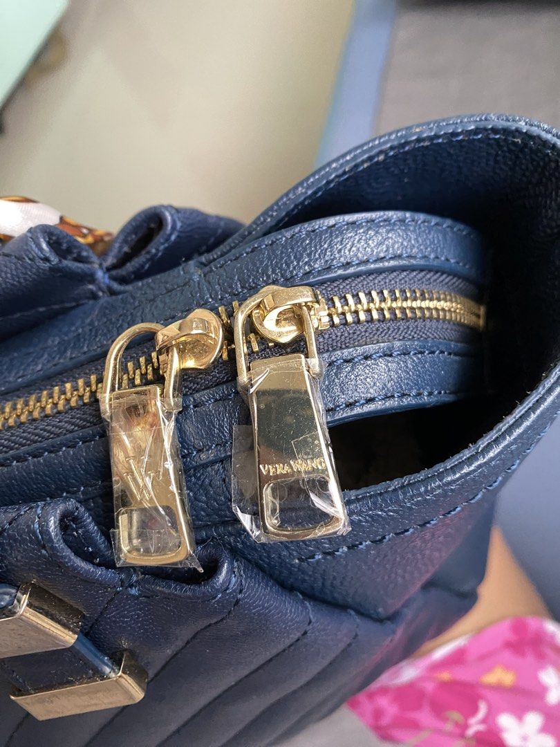 Authentic Vera Wang Bag (Category: Luxury Bags & Wallets) located in Cebu City. Submitted by quing1993 (Listing ID 1441218028, Image 3). Description: Authentic Vera Wang Navy Blue Chevron-Quilted exterior Medium 2-way bag No rubs Ni crackings Gold tone hardware You are buying pre-loved piece so expect signs of wear. Please inspect pictures and ask questions to avoid buyer's remorse. No return and no exchange. NO RETURN, NO EXCHANGE. Thank you!.