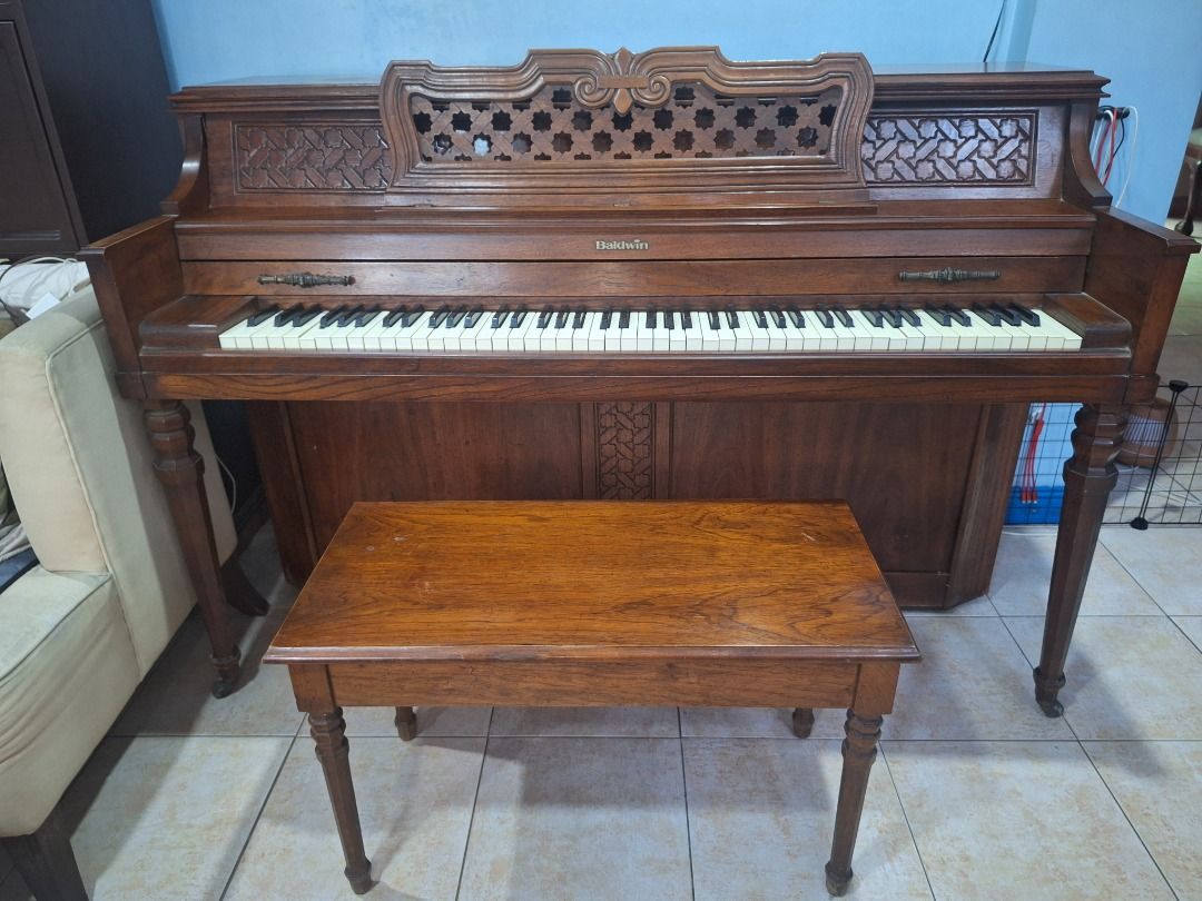 Baldwin Console Upright Piano w/ Bench – Needs Repair/Tuning (Category: Musical Instruments) located in Las Pinas. Submitted by homedispatch (Listing ID 1441211971, Image 1). Description: Baldwin Console Upright Piano w/ Bench – Made in USA – Needs Repair/Tuning We are selling our Baldwin console upright piano, US-made instrument suitable for beginners and families willing to have it serviced. Details: - Brand: Baldwin (Made in USA) - Type: Conso