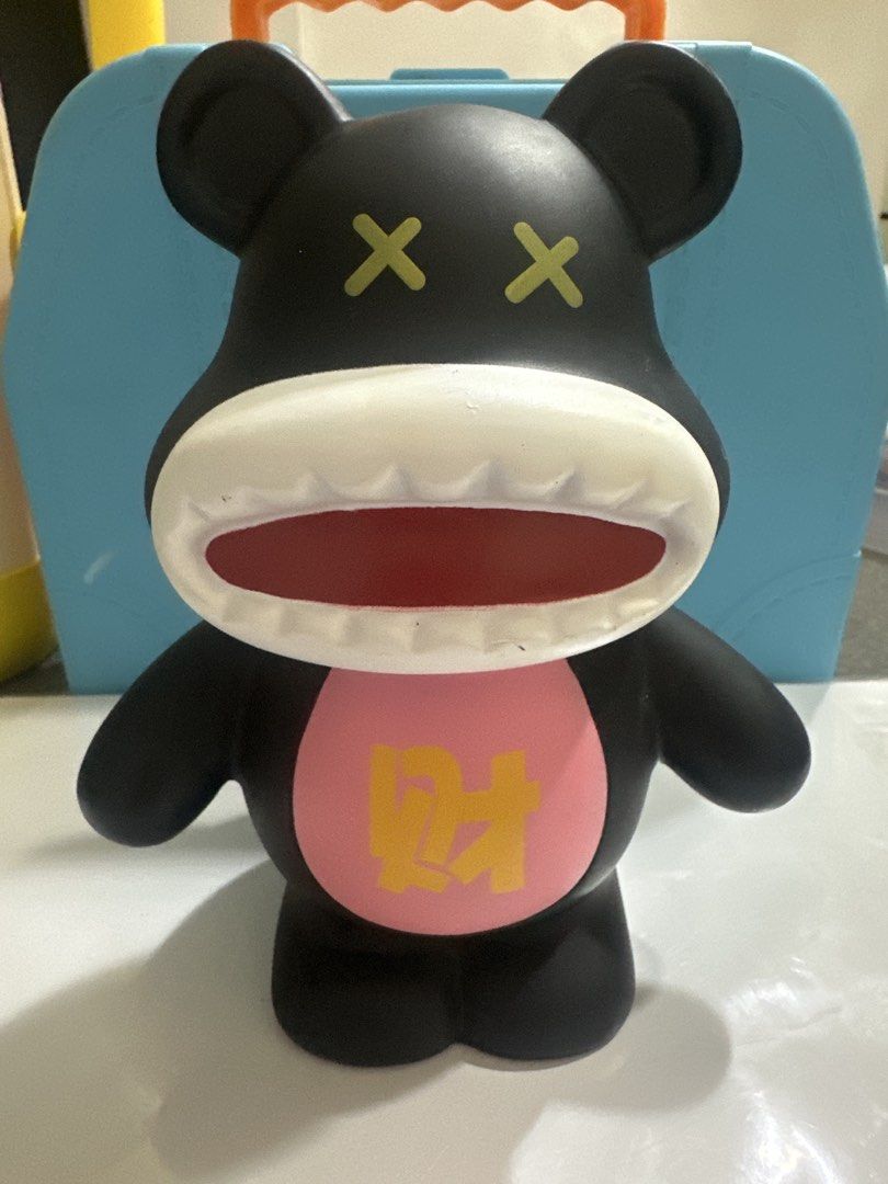 Black Bear Coin Bank Money Box (Category: Vintage Collectibles) located in Cainta. Submitted by shopbyyna (Listing ID 1441213721, Image 1). Description: - Adorable black bear design coin bank. - Convenient slot on the back for easy coin insertion. - Features a unique front design with a pink circle and gold character. - Playful wide open mouth and crossed-out eyes. - Ideal for saving your loose change. - Adds a fun and decorative element to any s