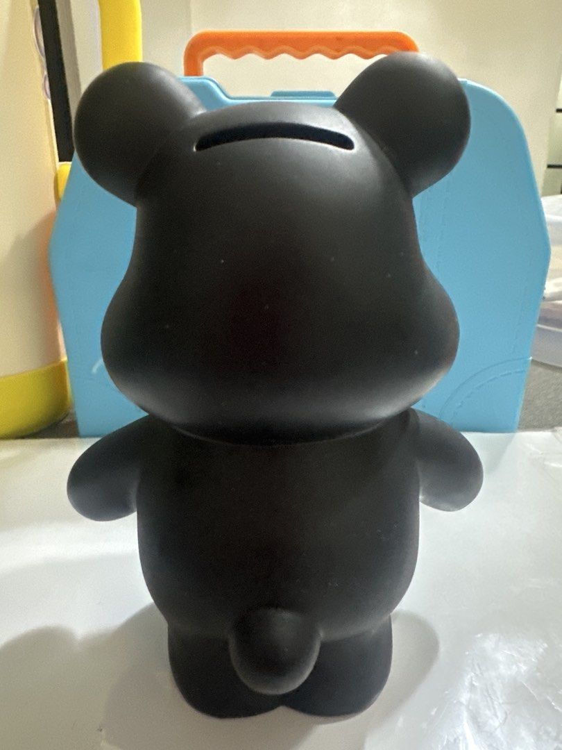 Black Bear Coin Bank Money Box (Category: Vintage Collectibles) located in Cainta. Submitted by shopbyyna (Listing ID 1441213721, Image 2). Description: - Adorable black bear design coin bank. - Convenient slot on the back for easy coin insertion. - Features a unique front design with a pink circle and gold character. - Playful wide open mouth and crossed-out eyes. - Ideal for saving your loose change. - Adds a fun and decorative element to any s