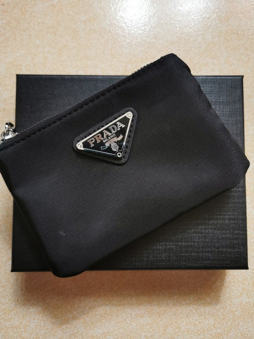 [GWP] Black Nylon Coin Pouch (Category: Luxury Bags & Wallets) located in Quezon City. Submitted by dcltrrr8 (Listing ID 1441215841, Image 1). Description: Gift with purchase when I bought perfume and makeup at the Prada Airport store in Japan. No receipt since freebie lang. Decent quality but not seamless hence why it's only GWP. 5.5x 3.5 inches - Black nylon material - Secure zipper closure - Interior card slots for organization - Comes with bo