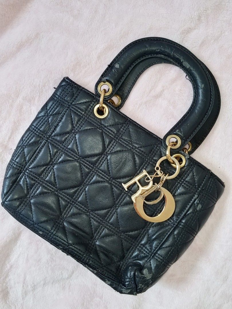 Black Quilted Bag (Category: Luxury Bags & Wallets) located in Manila. Submitted by aly_chy (Listing ID 1441214473, Image 1). Description: - Classic black Dior bag - Quilted leather with gold hardware - Features iconic Dior charms - Handle shows some wear - Corners have minor scuffs - Beautiful statement piece - Suitable for everyday use or special occasions.