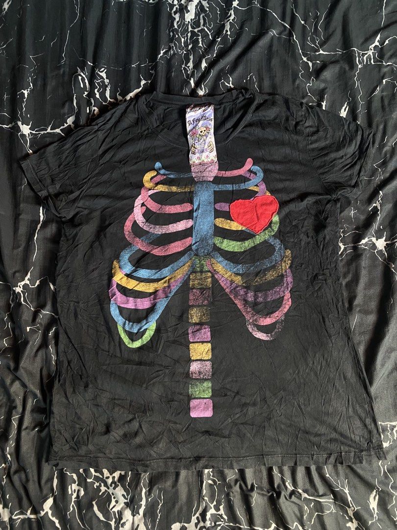 Black T-shirt with Rainbow Skeleton Print (Category: Tshirts & Polo Shirts ) located in San Pedro. Submitted by raprap.monte (Listing ID 1441256925, Image 1). Description: - Black t-shirt - Colorful skeleton graphic with a vintage, distressed look - Red heart detail over the ribcage - Made of soft material - Ideal for casual outfits or themed events.