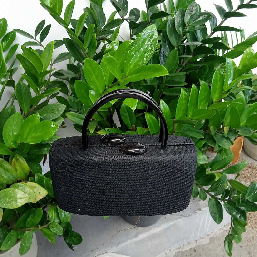 Black Woven Handbag with Unique Handle and Clasp (Category: Tote Bags) located in Quezon City. Submitted by ilovenystuff (Listing ID 1441287827, Image 3). Description: - Buntal black woven handbag - Unique curved shiny black short handle - Two dark oval clasps on top - Structured, boxy shape - Nice woven texture for a distinct look - Perfect for a night out or to elevate your style.