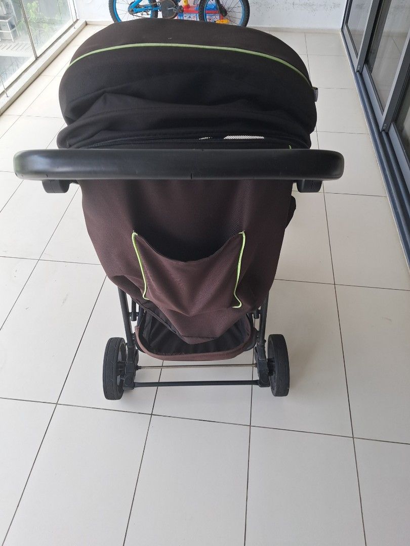Brown Baby Stroller (Category: Strollers) located in Singapore. Submitted by divaqueen1 (Listing ID 1441241176, Image 1). Description: - Brown stroller with lime green trim - Includes canopy for sun protection - Convenient storage basket underneath - Sturdy wheels for smooth rides - Folds compactly for easy storage - Ideal for convenient travel with your child.