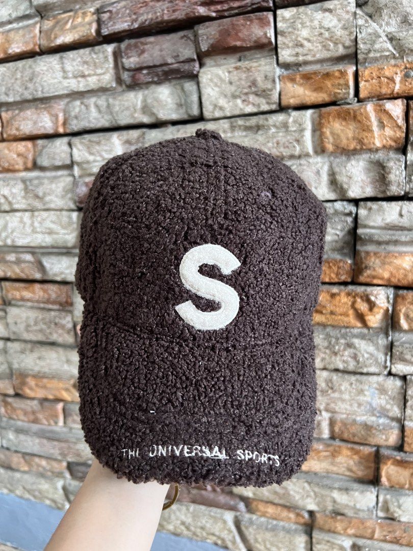 Brown Teddy Fleece Baseball Cap with 'S' Logo (Category: Caps & Hats) located in Manila. Submitted by markhie22 (Listing ID 1441225106, Image 1). Description: - Super cozy brown teddy fleece cap - Features a white 'S' logo on the front - 'THE UNIVERSAL SPORTS' embroidered on the brim - Adjustable strap at the back for a comfortable fit - Perfect for staying warm and stylish.