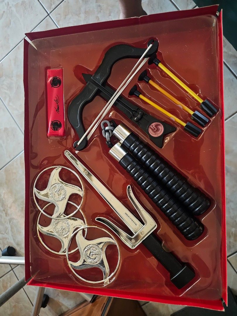 Bruce Lee Dagger and Crossbow Toy Set (Category: Action & Battle Toys) located in Muntinlupa City. Submitted by jojiepogi123 (Listing ID 1441236473, Image 2). Description: - Vintage Bruce Lee toy set - Includes dagger, nunchucks, throwing stars, and crossbow with arrows - Packaging shows some wear - Contents appear complete - Great for collectors and Bruce Lee fans - Fun piece of memorabilia.