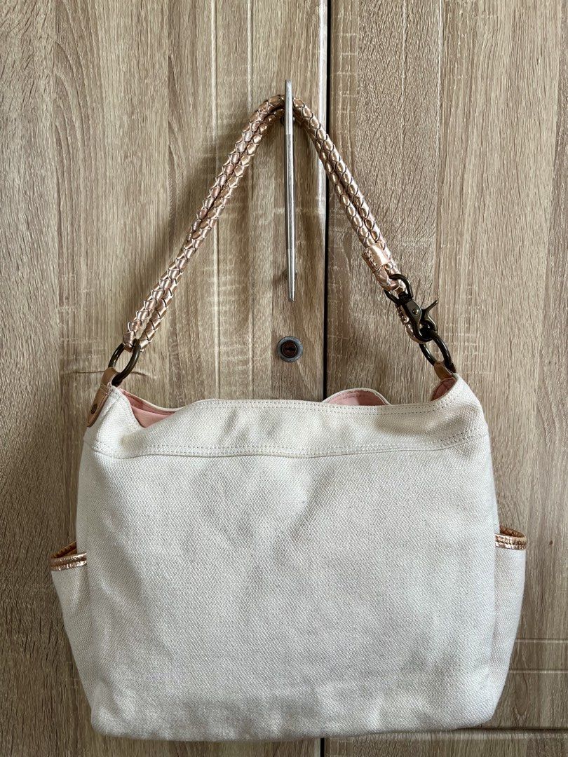 Burberry Blue Label Canvas Shoulder Bag (Category: Luxury Bags & Wallets) located in Calamba. Submitted by michCM (Listing ID 1441165274, Image 2). Description: - Authentic Burberry Blue Label white canvas shoulder bag - Elegant rose gold accents on straps and pocket edges - Iconic Burberry knight logo and 'Burberry Blue Label' print - Convenient side pockets for easy access - Stylish pink interior - Ideal for everyday wear and errands Issues: Co