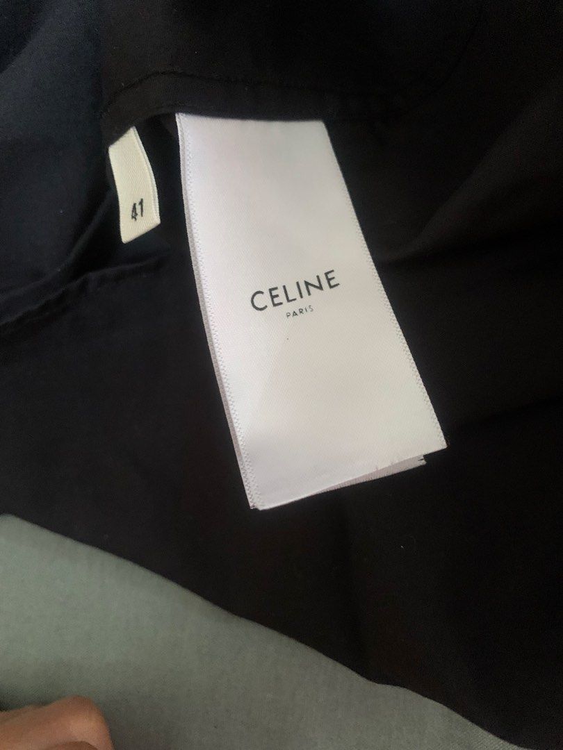 CELINE PARIS Black Long Sleeve Button Up Shirt (Category: Luxury Apparel) located in San Fernando. Submitted by balading (Listing ID 1441208474, Image 3). Description: - Classic black button-up shirt from CELINE PARIS. - Features a subtle 'C' detail near the hem. - Made in Italy. - Size: 41 - Ideal for smart casual or formal occasions..