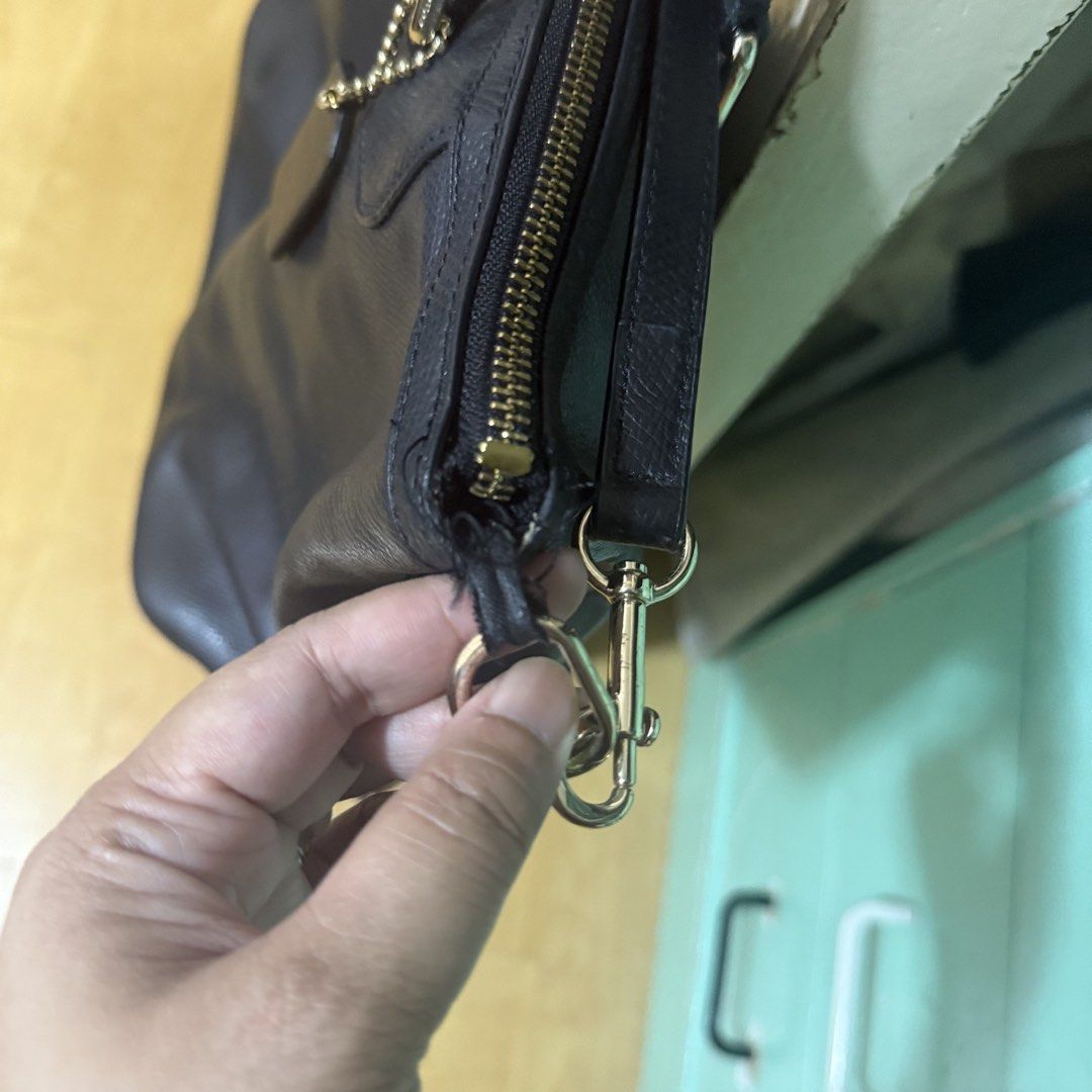 Coach Black Leather Tote Bag (Category: Luxury Bags & Wallets) located in Quezon City. Submitted by zoe_zee (Listing ID 1441306340, Image 2). Description: - Authentic Coach black leather tote bag - Secure zippered top closure - Multiple interior compartments for organization - Elegant gold hardware details - Shows some wear on strap attachment point - Perfect for everyday use.