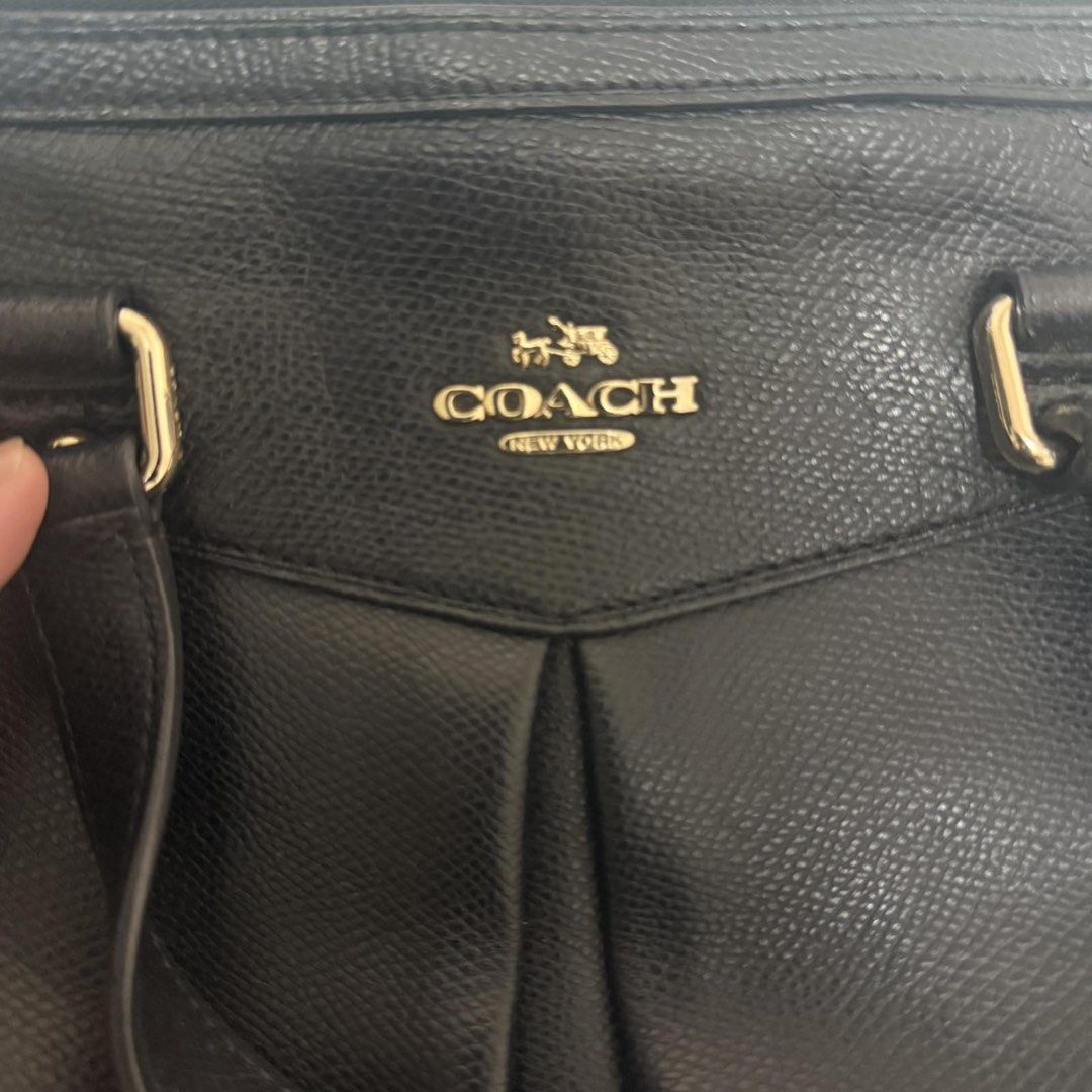 Coach Black Leather Tote Bag (Category: Luxury Bags & Wallets) located in Quezon City. Submitted by dtzee (Listing ID 1441315065, Image 2). Description: - Authentic black leather Coach tote bag - Elegant gold hardware details - Secure top zipper closure - Includes a small leather Coach tag - Minor wear on the zipper pull tab - Ample interior space for all your essentials.