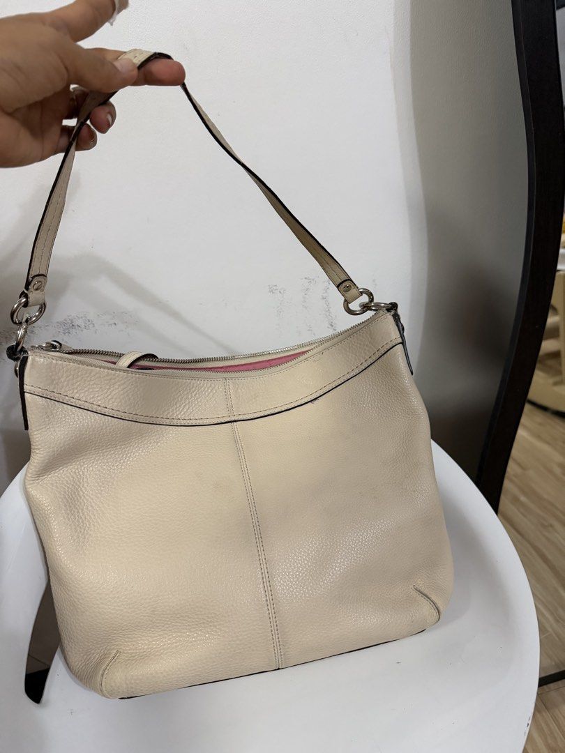 Coach Leather Shoulder Bag Cream Pink Interior (Category: Luxury Bags & Wallets) located in Danao, Cebu. Submitted by anne_2016143 (Listing ID 1441267343, Image 3). Description: - Authentic Coach cream leather shoulder bag - Features a stylish pink interior lining - Leather shows some signs of wear, as pictured - Adjustable strap for comfortable wear - A timeless and versatile everyday bag.