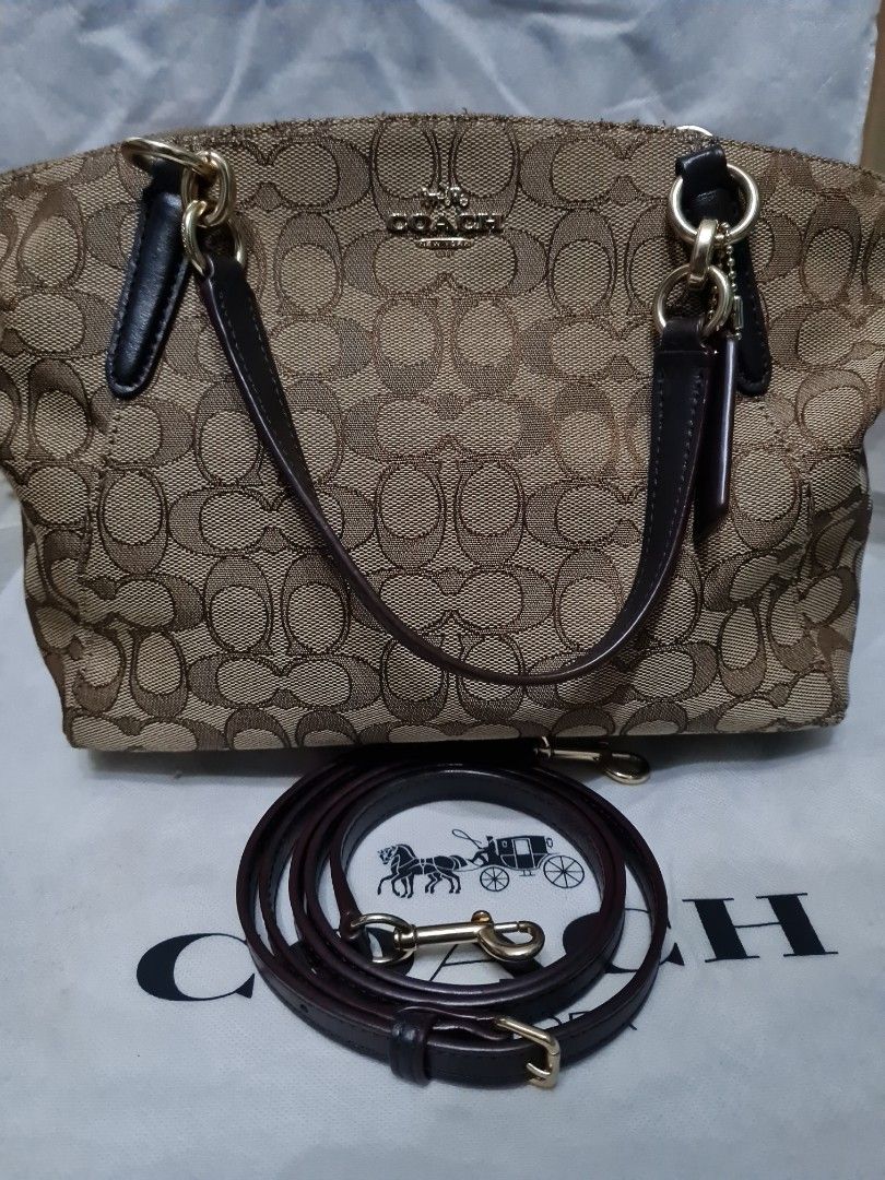 Coach Signature Canvas Shoulder Bag with Strap (Category: Luxury Bags & Wallets) located in Batangas. Submitted by mariroz (Listing ID 1441309102, Image 1). Description: - 100 💯 Authentic Coach shoulder bag in brown and gold signature canvas. - Bought from Coach Japan - Textured canvas finish for a stylish look. - Elegant gold hardware details throughout. - Includes a detachable dark brown leather strap. - Strap features the classic Coach horse 