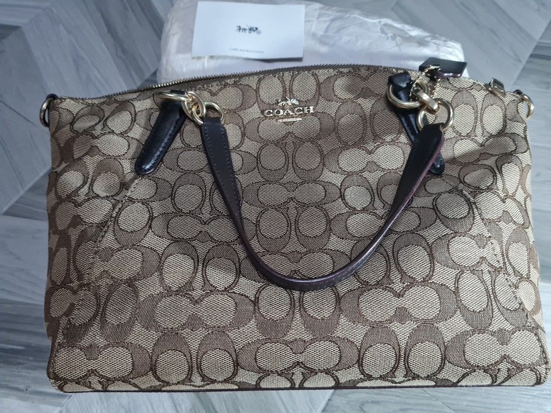 Coach Signature Canvas Shoulder Bag with Strap (Category: Luxury Bags & Wallets) located in Batangas. Submitted by mariroz (Listing ID 1441309102, Image 2). Description: - 100 💯 Authentic Coach shoulder bag in brown and gold signature canvas. - Bought from Coach Japan - Textured canvas finish for a stylish look. - Elegant gold hardware details throughout. - Includes a detachable dark brown leather strap. - Strap features the classic Coach horse 