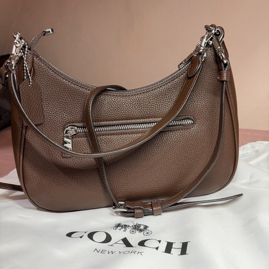 Coach Teri Hobo in Maple Brown Regular Size (Category: Shoulder Bags) located in Quezon City. Submitted by active_assets (Listing ID 1441232355, Image 3). Description: - maple brown Coach hobo bag - Made from premium pebbled leather - Secure zip closure - Convenient exterior zip pocket - Elegant silver hardware details - Adjustable strap for versatile shoulder or crossbody wear - Comes with dust bag.