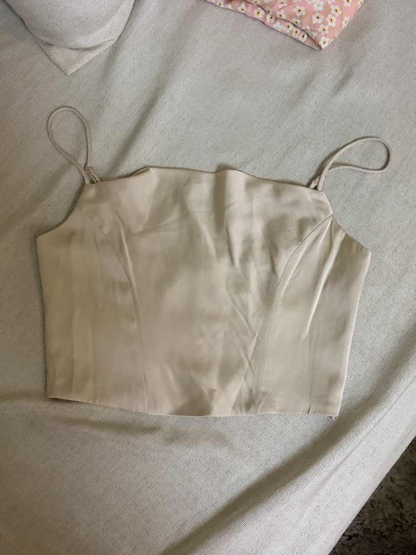 Cream Cowl Neck Corset Crop Top (Category: Sleeveless) located in Manila. Submitted by zam1994 (Listing ID 1441333509, Image 2). Description: - Cream cowl neck corset crop top - Spaghetti straps - Satin-like material - Ideal for nights out or special occasions - Versatile: pair with jeans or a skirt.