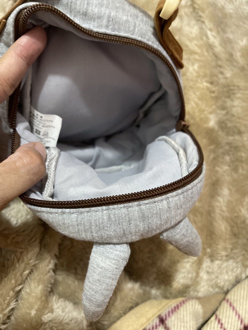 Cute Totoro Coin Pouch Bag (Category: Purses & Pouches) located in Arayat. Submitted by imeon13 (Listing ID 1441341747, Image 3). Description: - Adorable Totoro pouch - Made of soft grey fabric with charming embroidered details - Secure zipper closure - Features a small handle with a convenient clip - Ideal for storing coins, small essentials, or as a cute accessory - A must-have for Studio Ghibli fans - Approximately 4 inches tall.