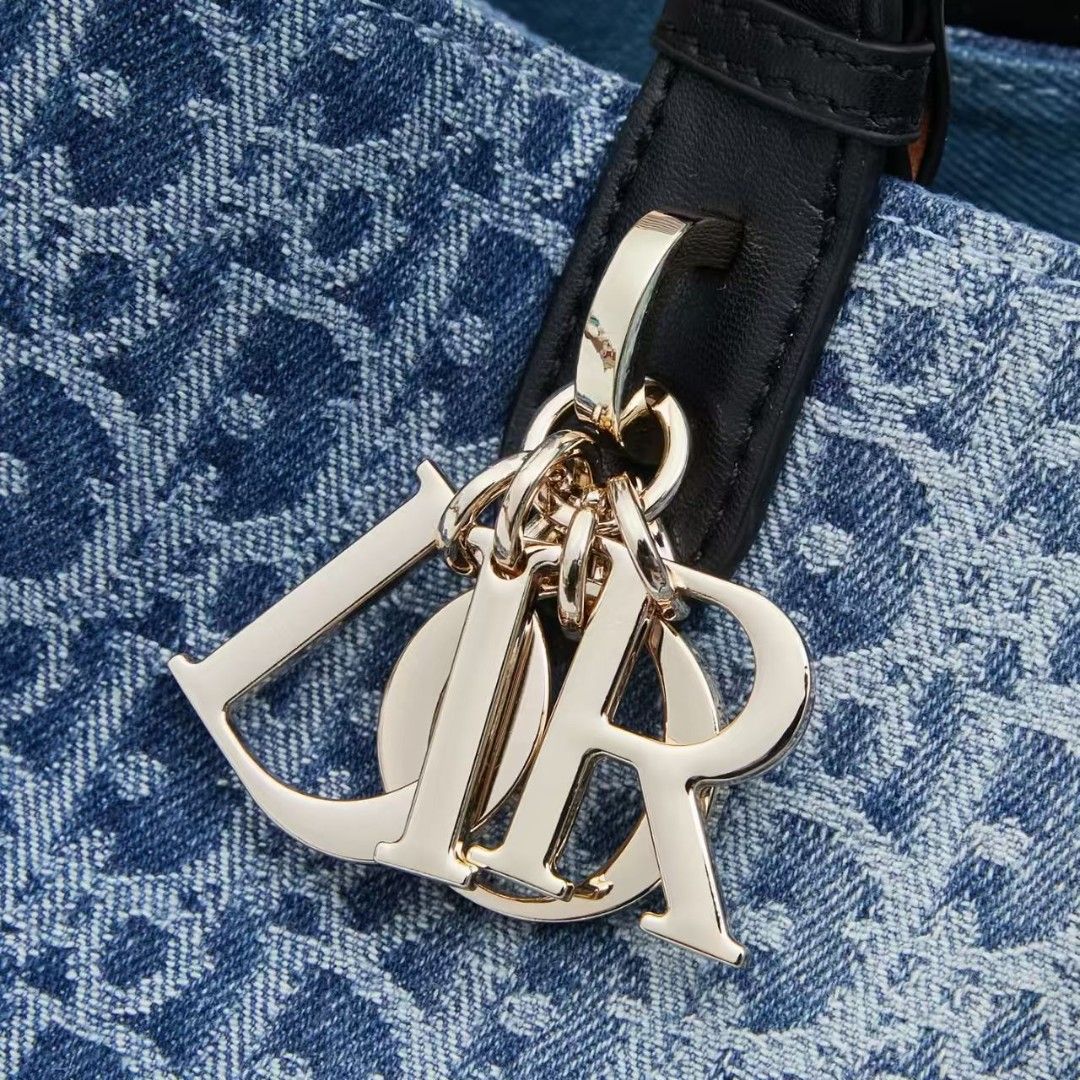 Dior Denim Monogram Tote Bag with Pouch (Category: Luxury Bags & Wallets) located in Manila. Submitted by brekkas.ph (Listing ID 1441228931, Image 1). Description: - Authentic Dior tote bag - Classic blue denim with signature monogram print - Includes a matching zippered pouch - Durable black leather handles and trim - Elegant gold-tone 'Dior' charms - Ideal for everyday style and practicality P12800.