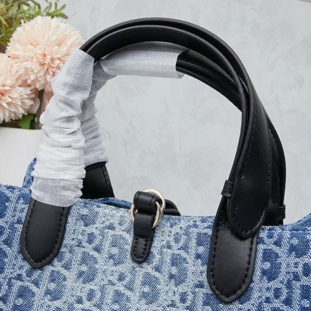Dior Denim Monogram Tote Bag with Pouch (Category: Luxury Bags & Wallets) located in Manila. Submitted by brekkas.ph (Listing ID 1441228931, Image 3). Description: - Authentic Dior tote bag - Classic blue denim with signature monogram print - Includes a matching zippered pouch - Durable black leather handles and trim - Elegant gold-tone 'Dior' charms - Ideal for everyday style and practicality P12800.
