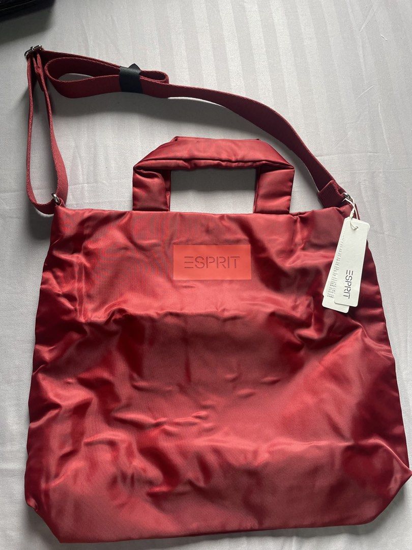 SALE Esprit Red Nylon Tote Bag with Shoulder Strap (Category: Tote Bags) located in Manila. Submitted by arabellaa859130 (Listing ID 1441206781, Image 1). Description: - Red Esprit tote bag - Made of durable nylon - Comfortable top handles - Adjustable shoulder strap for versatility - Brand new with original tags attached - Spacious interior for all your essentials - Ideal for everyday errands or travel adventures.