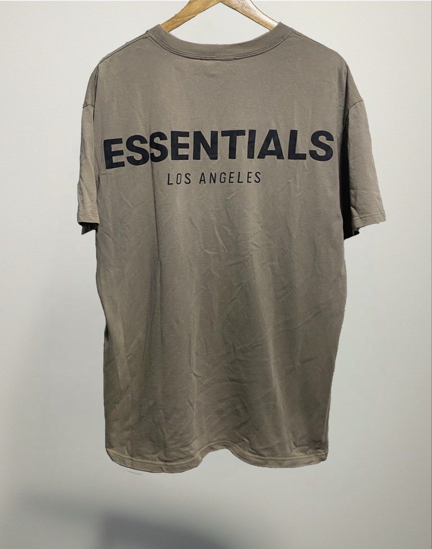 Fear of God Essentials Los Angeles T-Shirt (Category: Tshirts & Polo Shirts ) located in Naga. Submitted by thesource4400 (Listing ID 1441318350, Image 2). Description: - Brand: Fear of God Essentials - Color: Brown - Front Graphic: 'ESSENTIALS FEAR OF GOD' - Back Graphic: 'ESSENTIALS LOS ANGELES' - Style: Casual, comfortable, and stylish.