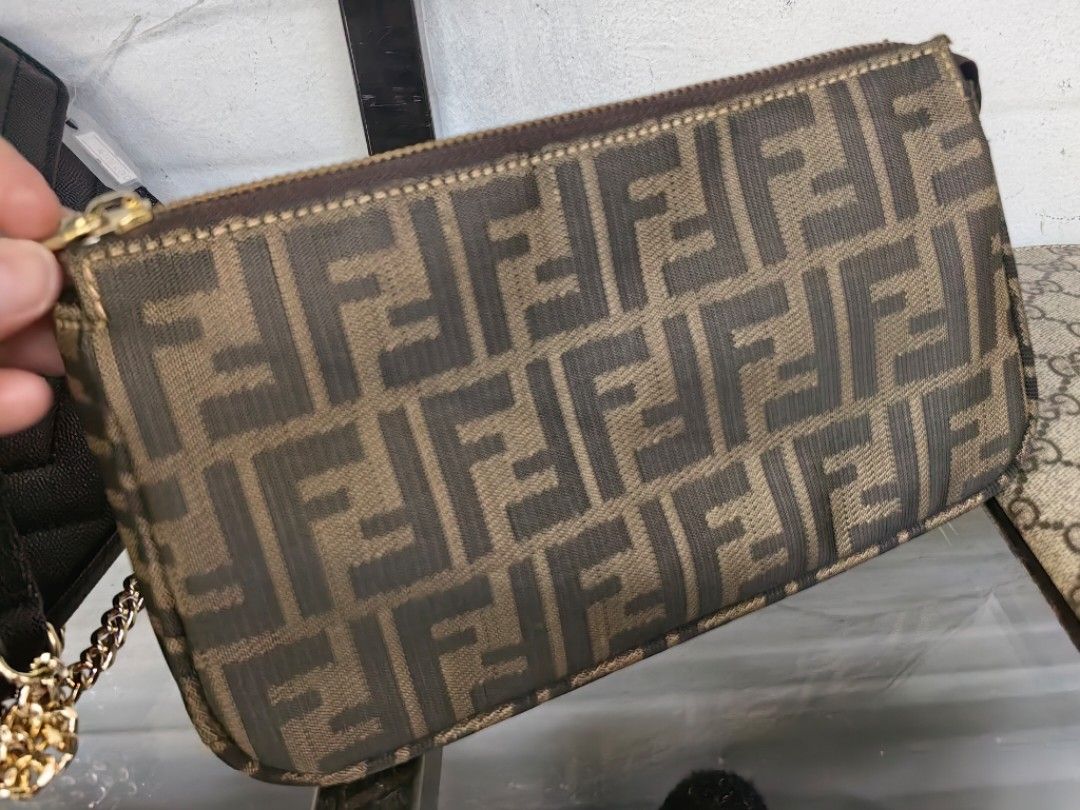 Fendi Zucca Monogram Pouch (Category: Luxury Bags & Wallets) located in Quezon City. Submitted by flat.earther23 (Listing ID 1441182135, Image 1). Description: - Authentic Fendi Zucca monogram pouch - Color: Brown and tan canvas - Closure: Zipper - Interior: Zippered pocket - Hardware: Gold tone - Ideal for carrying essentials.