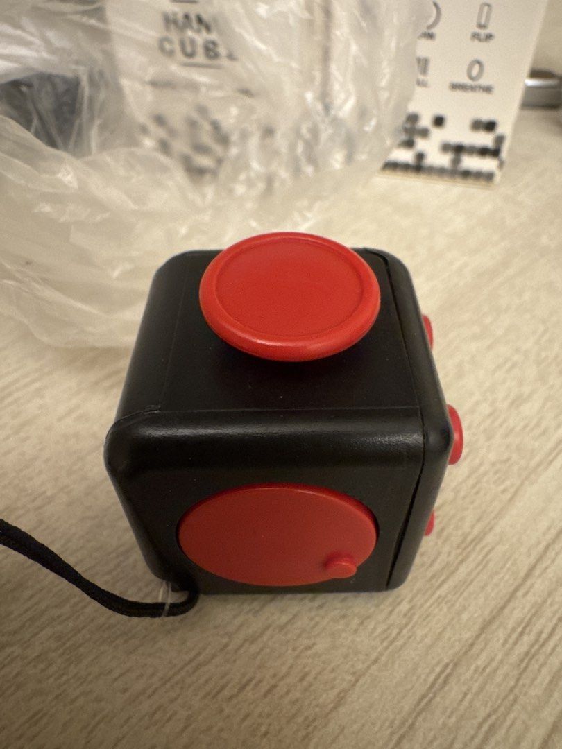 Fidget Cube (Category: Interactive Toys) located in Singapore. Submitted by activesell (Listing ID 1441334872, Image 4). Description: Brand new have 2 in stock. One with red buttons and one with black buttons. $2 each.