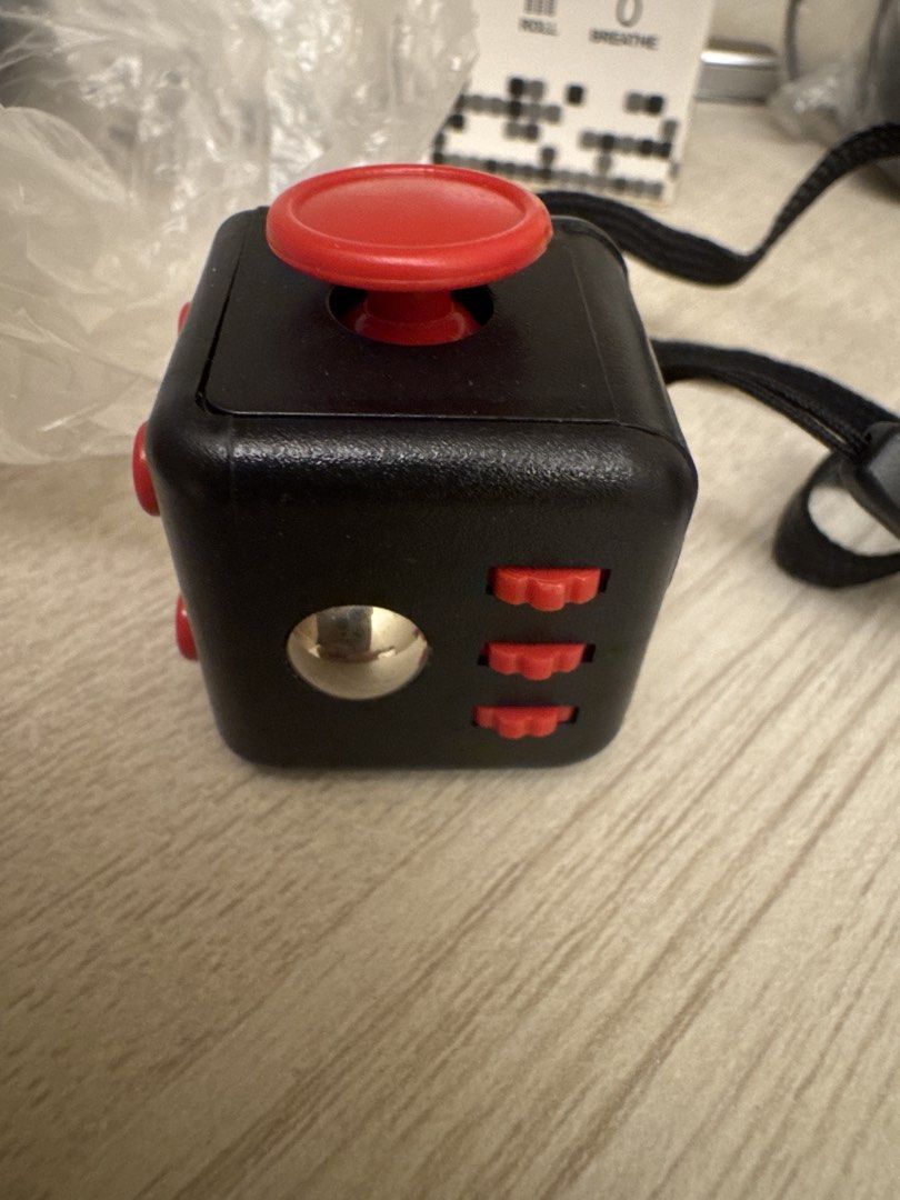 Fidget Cube (Category: Interactive Toys) located in Singapore. Submitted by activesell (Listing ID 1441334872, Image 2). Description: Brand new have 2 in stock. One with red buttons and one with black buttons. $2 each.
